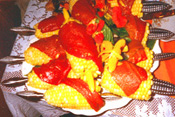 Corn on the cob wrapped in roasted red peppers